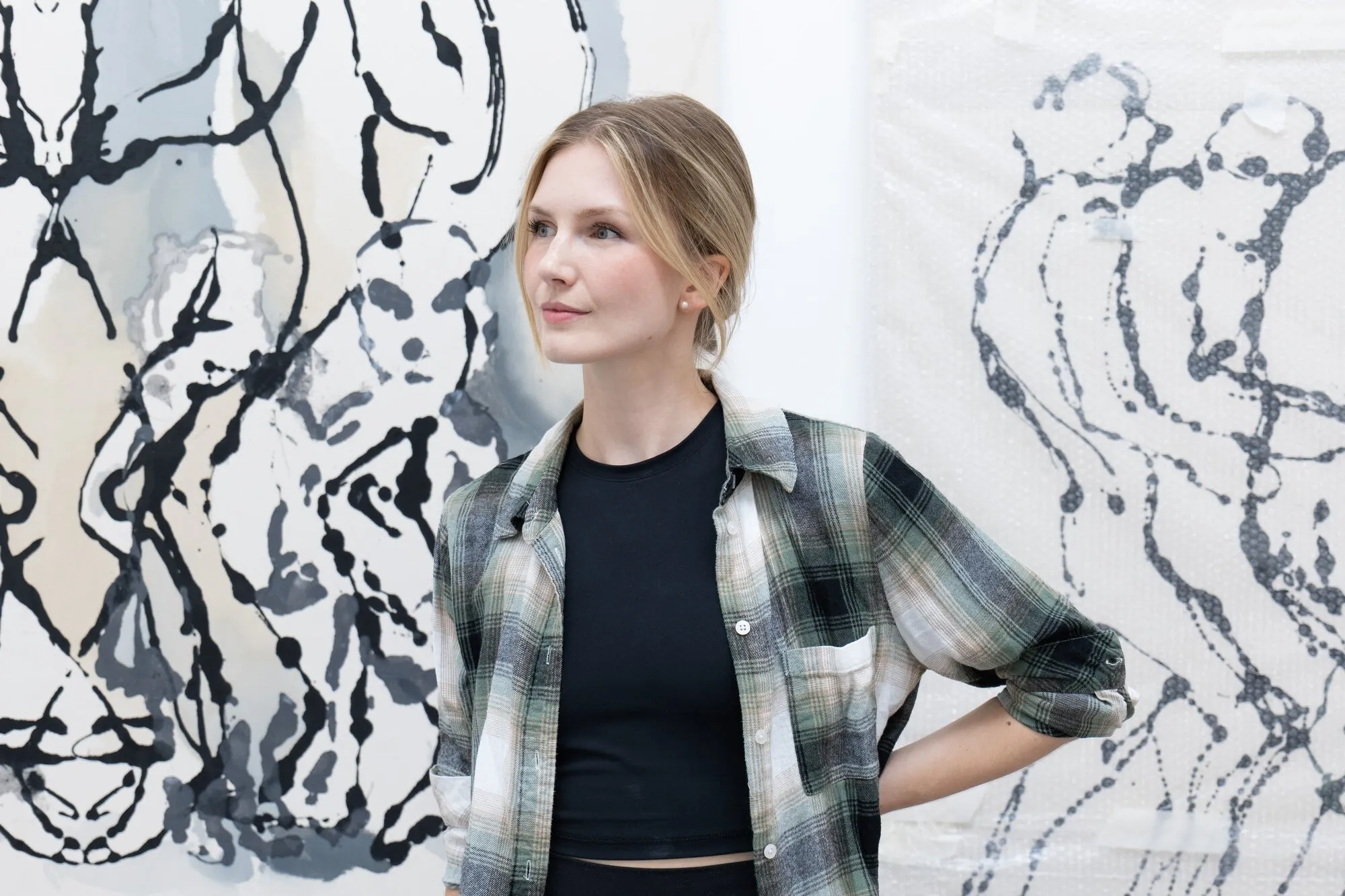 Edyta in her studio, in front of her black and white works