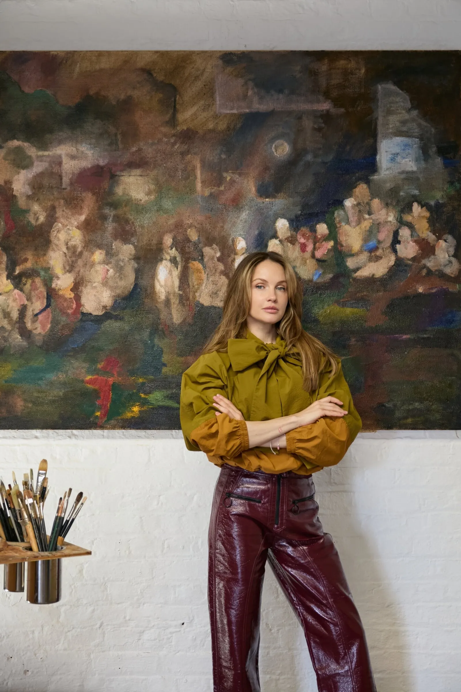 Marina Priyomova in front of her work on burlap