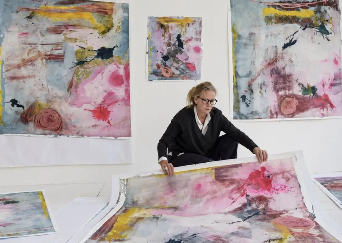 Stacie McCormick working on a painting on the studio floor